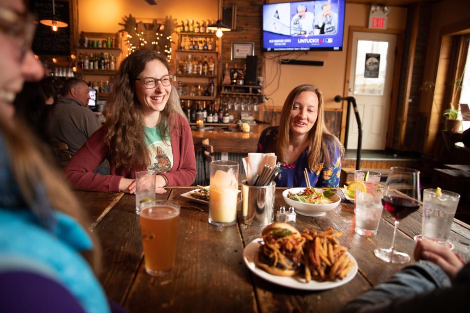 People enjoy food and drinks at a pub and brewery