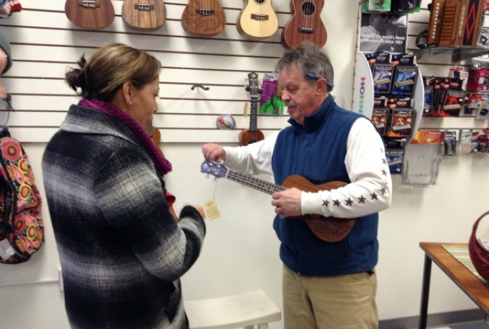 Mark the music man, Ampersound proprietor, demonstrates some ukulele moves for a customer