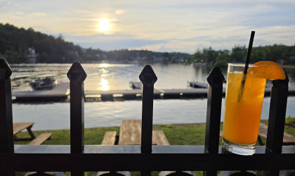 A sunset view of the lake from the patio with a freshly poured beverage