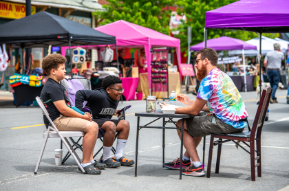 Artist draws kids at Party on Park