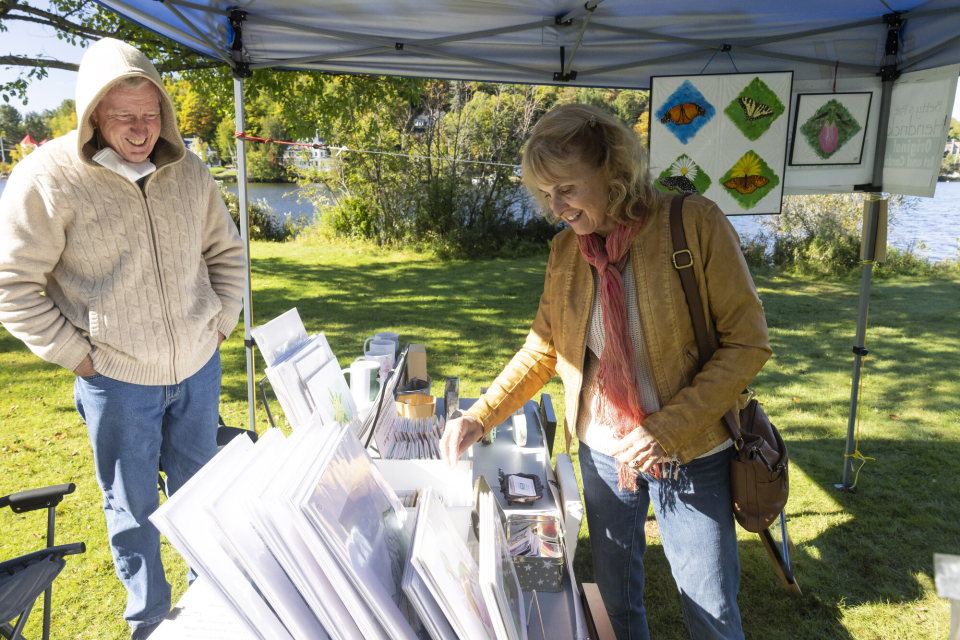 A woman looks at an assortment on prints