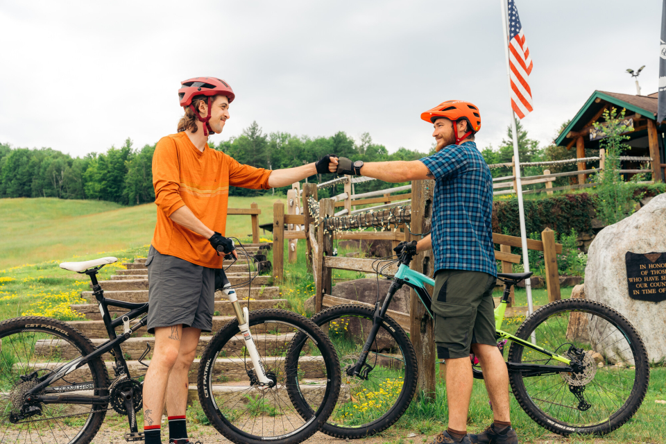 Two mountain bikers fist pump