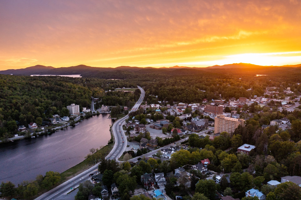 An aerial shot of the sun setting over Saranac Lake