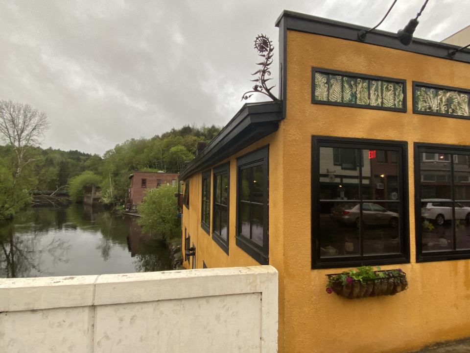 yellow building decorated with fiddlehead ferns