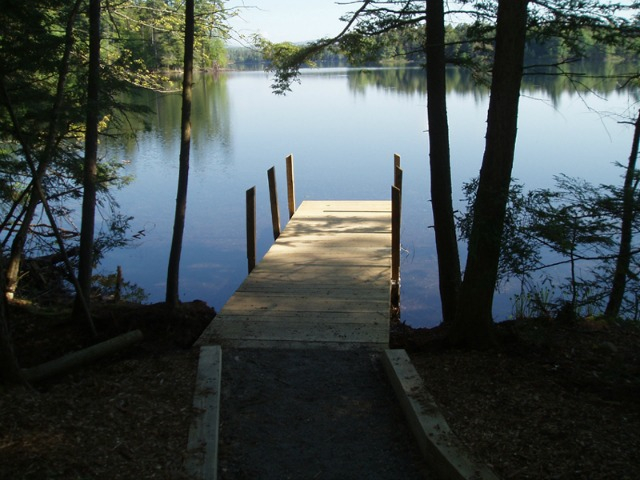 A dock on Follensby Clear Pond providing a picture-perfect start to a popular Adirondack canoe route