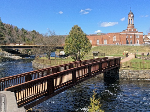 The first bridge of the Riverwalk crosses the Saranac River right below the dam.