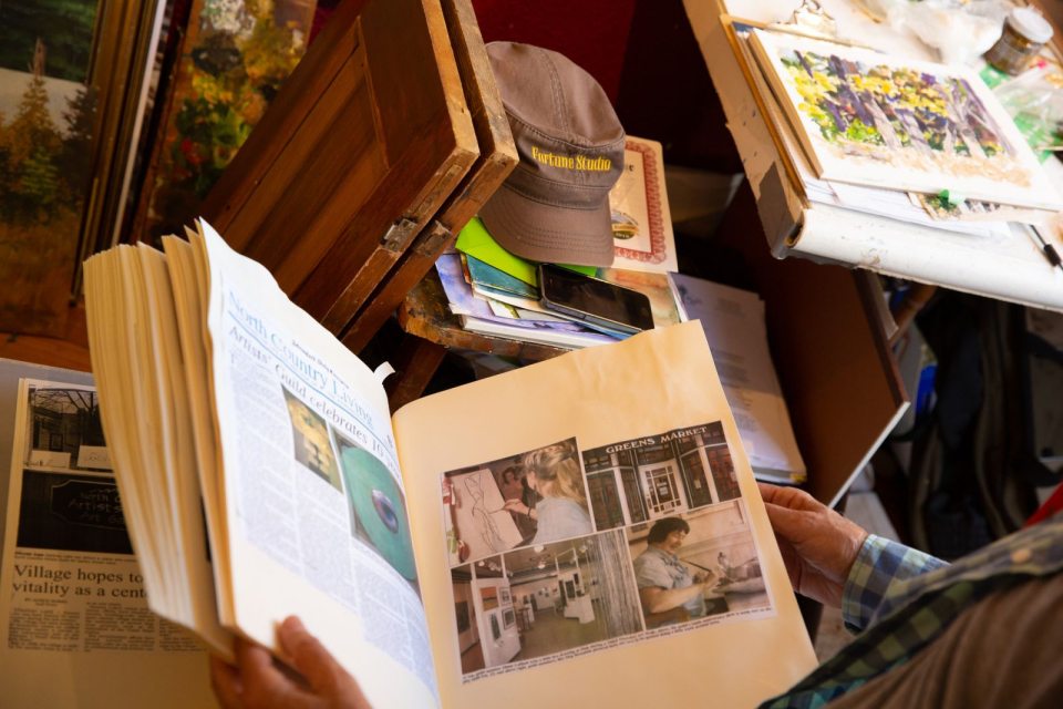 Tim looks at his collection of ArtWalk news articles.