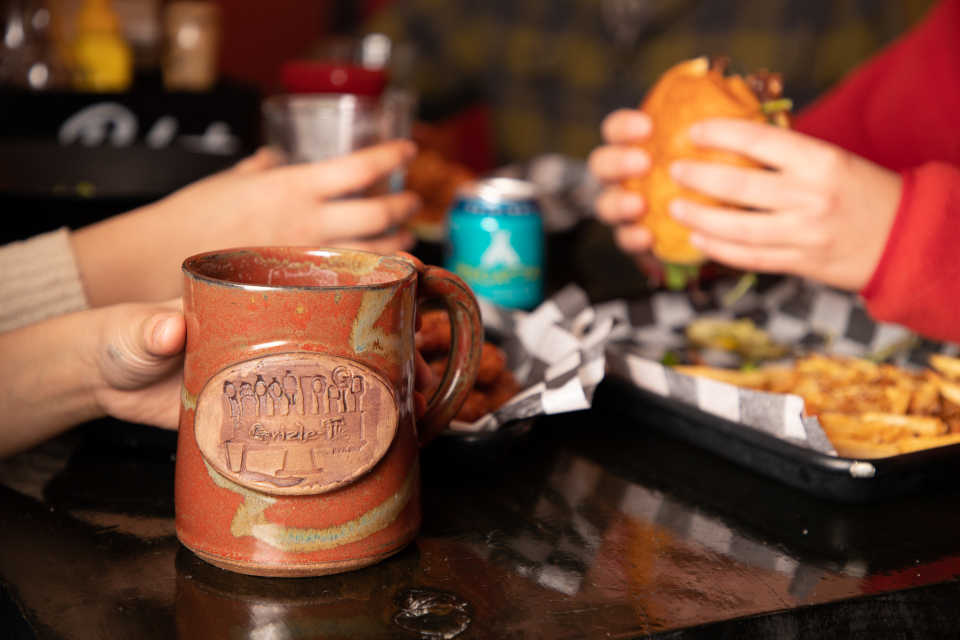 Two people eat and drink at a restaurant.