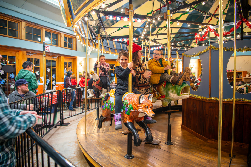 Kids riding a carousel in the winter