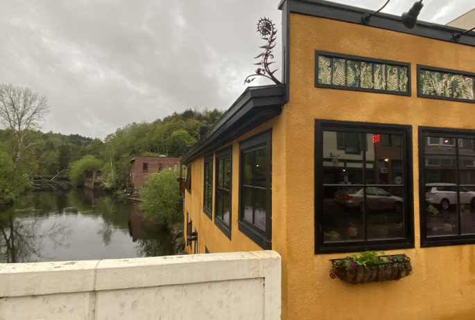 yellow building decorated with fiddlehead ferns