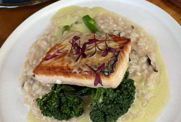 Close-up of a plate of salmon with brocolini and ramp butter