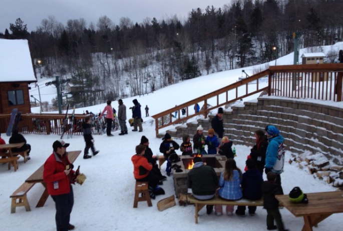 End of the day - warming up by the fire before heading out for night skiing!