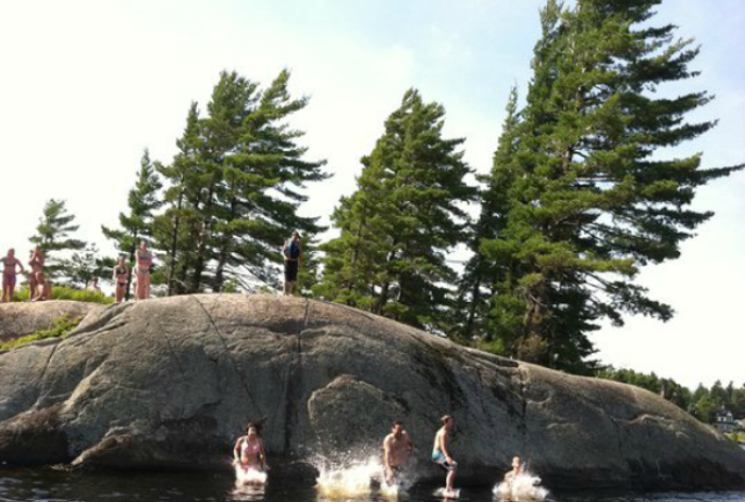 Take the boat to some fantastic destinations, like this famous diving rock on Lower Saranac Lake.