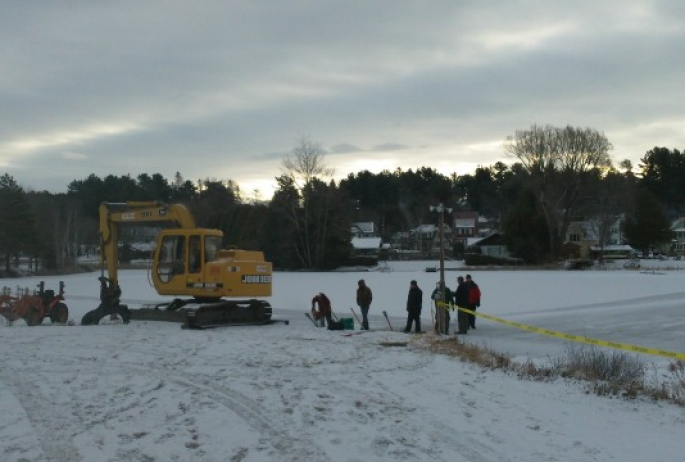 construction begins at daybreak, with heavy equipment (on land) and hand tools (on ice)