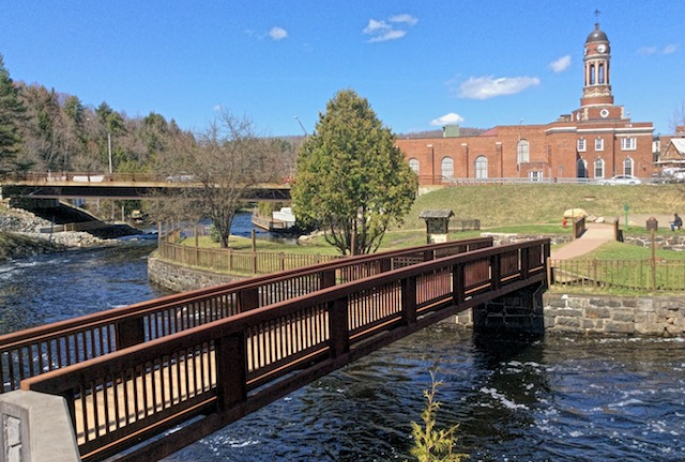 The first bridge of the Riverwalk crosses the Saranac River right below the dam.