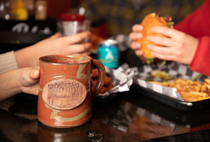 Two people eat and drink at a restaurant.