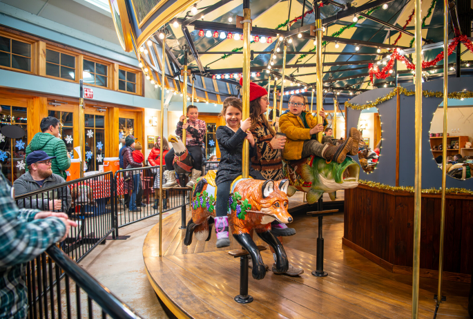 Kids riding a carousel in the winter