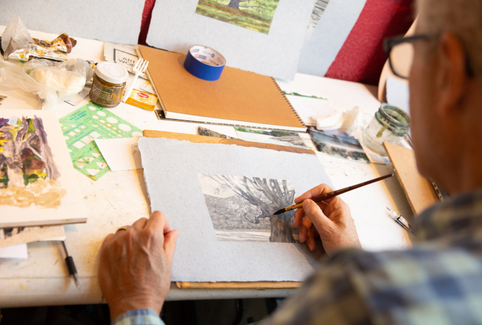 A local artist working on watercolor painting.