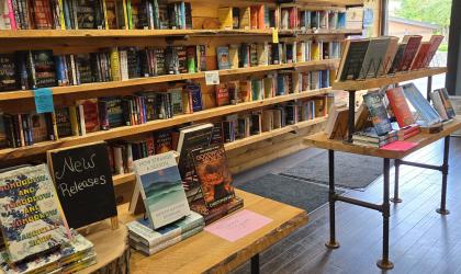 Walls and tables lined with Romance, Mystery, Fiction and Newly Released Books